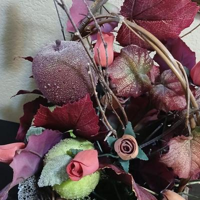 Beautiful fall bouquet with wooden roses in a basket with a doiley
