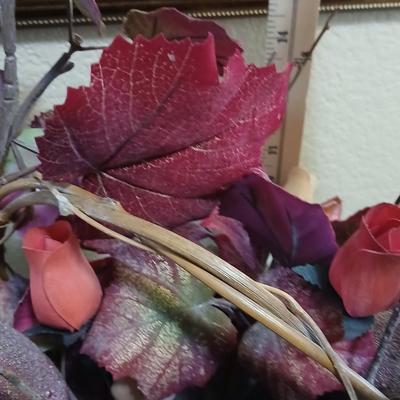 Beautiful fall bouquet with wooden roses in a basket with a doiley