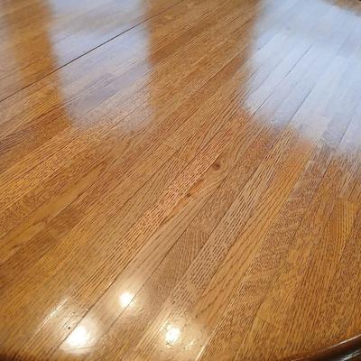 Beautiful slat oak dining room table with 4 upholstered chairs and 2 leaves