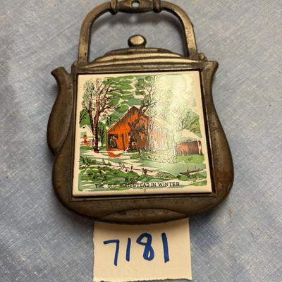 Cast iron trivet homestead in winter