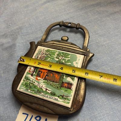 Cast iron trivet homestead in winter