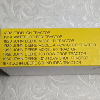 Box of Collector's John Deere Tractors