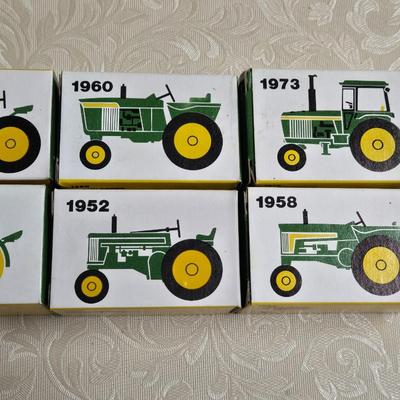 Box of Collector's John Deere Tractors