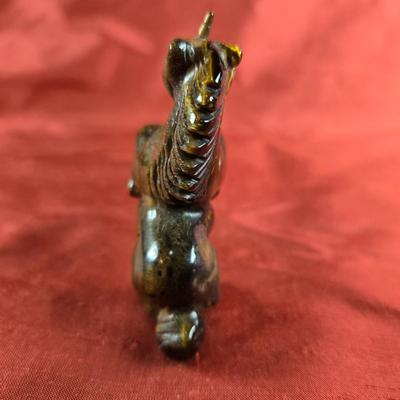 Sale Photo Thumbnail #442: This auction lot is for a Tiger Eye Unicorn.  The unicorn is carved out of Tiger Eye.  It has a wonderful sheen and glow movement associated with Tiger Eye.  The unicorn is in a rearing position, standing about 2.5-inches tall including horn.