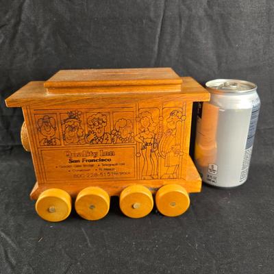 Sale Photo Thumbnail #469: This auction lot is for a Vintage Wooden Trolley Bank. This nicely made wooden trolley bank was a souvenir from the Quality Inn, San Francisco.  The trolley was made by Toystalgia in 1980.  It is large enough to hold a substantial amount of coins.  It is 