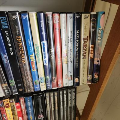 Large Media Lot w rack DVDs CDs Blu-Ray Cassettes Wkrp Star Wars Elvis Disney 007
