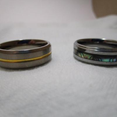 2 rings one is titanium with gold stripe size 12, one is mother of pearl size 13
