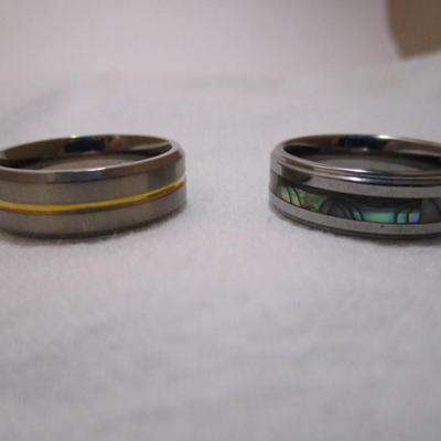 2 rings one is titanium with gold stripe size 12, one is mother of pearl size 13
