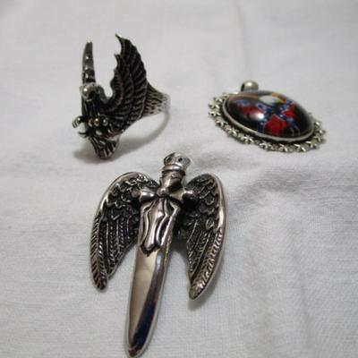 1 ring with eagle on it size 12, 2 pendants (one has an eagle with rebel flag, one is a cross with wings