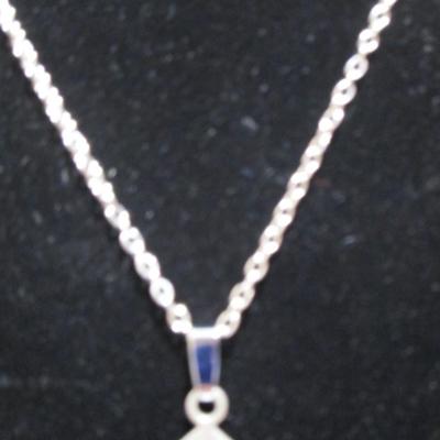 Cross (2" x 1-1/4) with a clear stone in the middle and with 19" chain