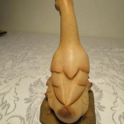 Hand-carved Duck family  looking at a Frog