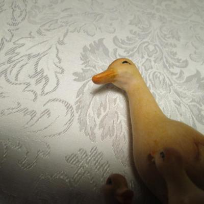 Hand-carved Duck family  looking at a Frog