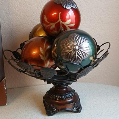 Metal decorative bowl with leaves and decorative balls inside with a brand-new picture frame