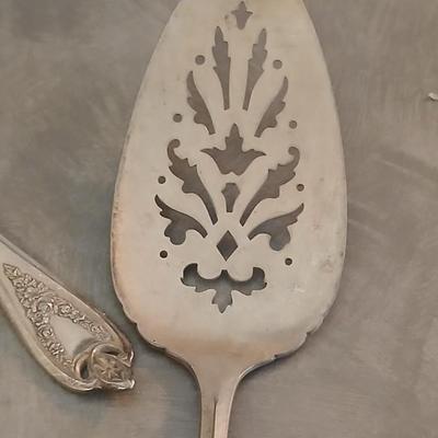 Assortment of vintage silverplate flatware and a candle holder with glass globe