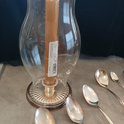 Assortment of vintage silverplate flatware and a candle holder with glass globe