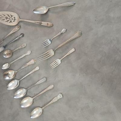 Assortment of vintage silverplate flatware and a candle holder with glass globe