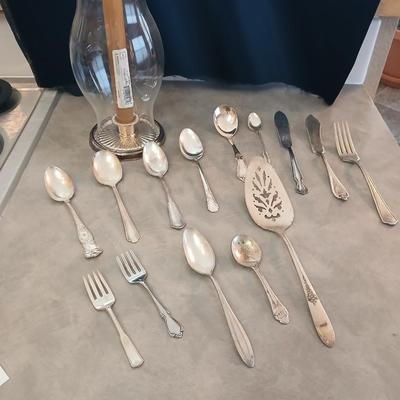 Assortment of vintage silverplate flatware and a candle holder with glass globe