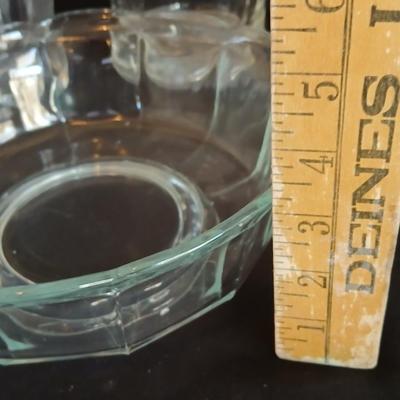 Glass water pitcher with six small juice glasses and a snack bowl with a platter