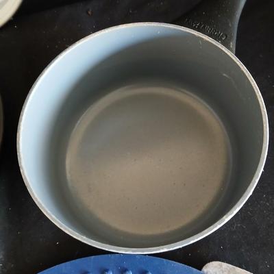 Variety of cooking pans and saucepans with silicone server and hot pads