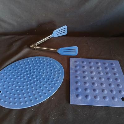 Variety of cooking pans and saucepans with silicone server and hot pads