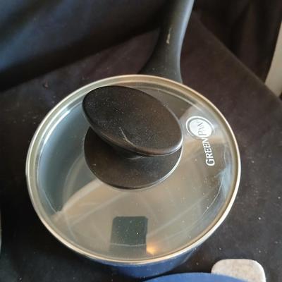 Variety of cooking pans and saucepans with silicone server and hot pads