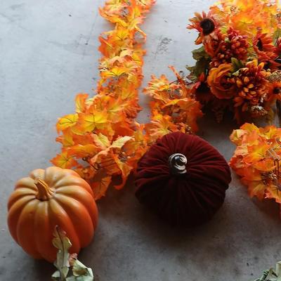 Faux fall leaves with pumpkins on a vine and three decorative pumpkins