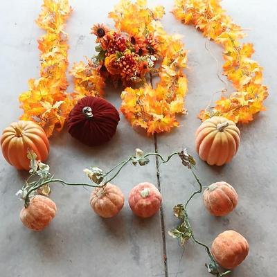 Faux fall leaves with pumpkins on a vine and three decorative pumpkins