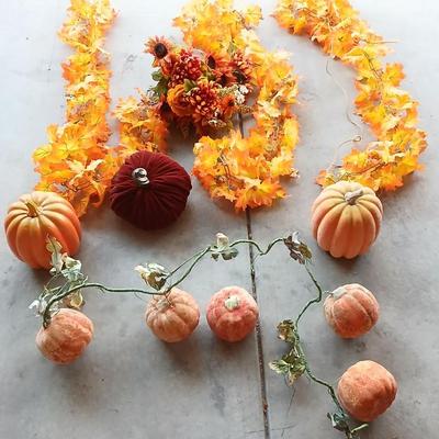 Faux fall leaves with pumpkins on a vine and three decorative pumpkins