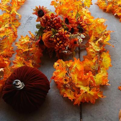 Faux fall leaves with pumpkins on a vine and three decorative pumpkins