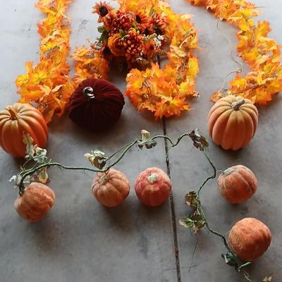 Faux fall leaves with pumpkins on a vine and three decorative pumpkins