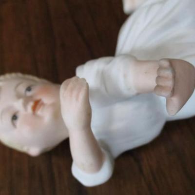 Antique bisque porcelain piano baby