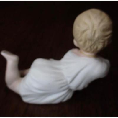 Antique bisque porcelain piano baby