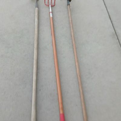 An older harrowing tool, a hoe and a cultivator