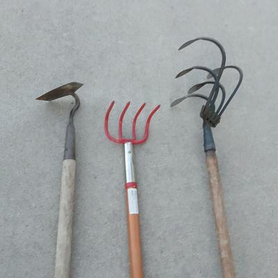 An older harrowing tool, a hoe and a cultivator