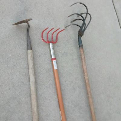 An older harrowing tool, a hoe and a cultivator