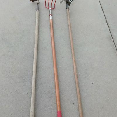 An older harrowing tool, a hoe and a cultivator