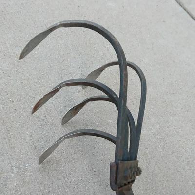 An older harrowing tool, a hoe and a cultivator