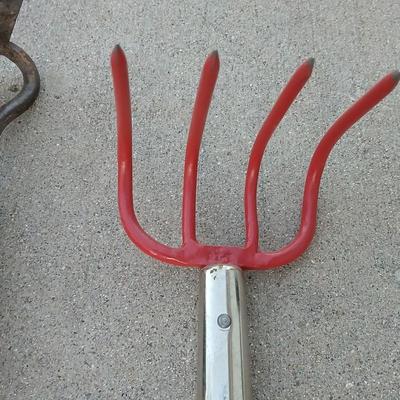 An older harrowing tool, a hoe and a cultivator