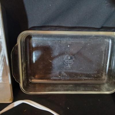 Baking pans, with large glass mixing bowl, cooling rack, and Kitchen Gourmet electric mixer