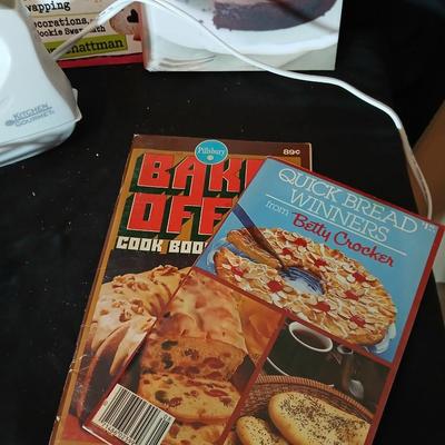 Baking pans, with large glass mixing bowl, cooling rack, and Kitchen Gourmet electric mixer