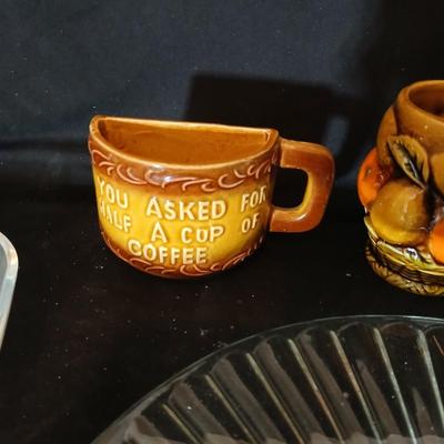 A half cup of coffee mug, divided glass tray, large bowl with plate, glass platter and more