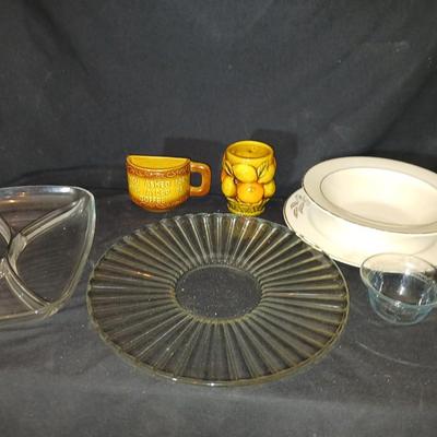 A half cup of coffee mug, divided glass tray, large bowl with plate, glass platter and more