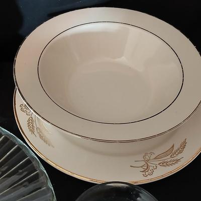A half cup of coffee mug, divided glass tray, large bowl with plate, glass platter and more