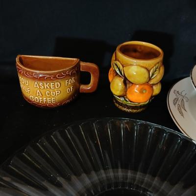 A half cup of coffee mug, divided glass tray, large bowl with plate, glass platter and more