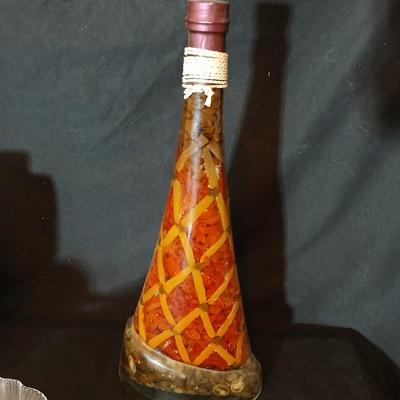 Two decorative garnish bottles with a glass plate and faux fruit