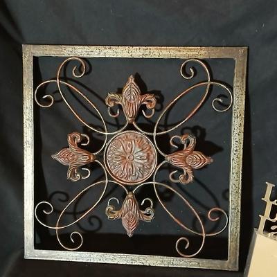 Square metal wall art and a Live Laugh Love photo frame