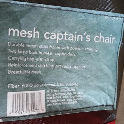 Mesh folding camp chair with carry bag and a green igloo drink cooler