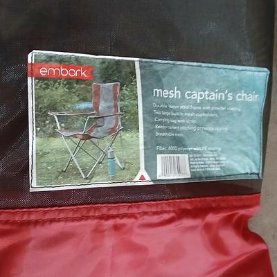 Mesh folding camp chair with carry bag and a green igloo drink cooler