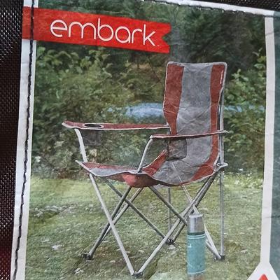 Mesh folding camp chair with carry bag and a green igloo drink cooler
