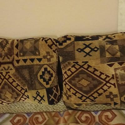 Two throw pillows and a handmade knot lap blanket